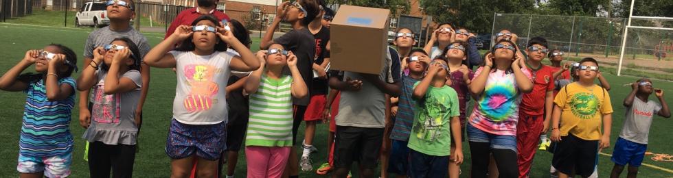 ABCD Camp attendees looking at solar eclipse.