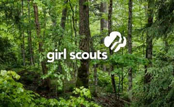 Girl Scouts logo superimposed on forest scene.